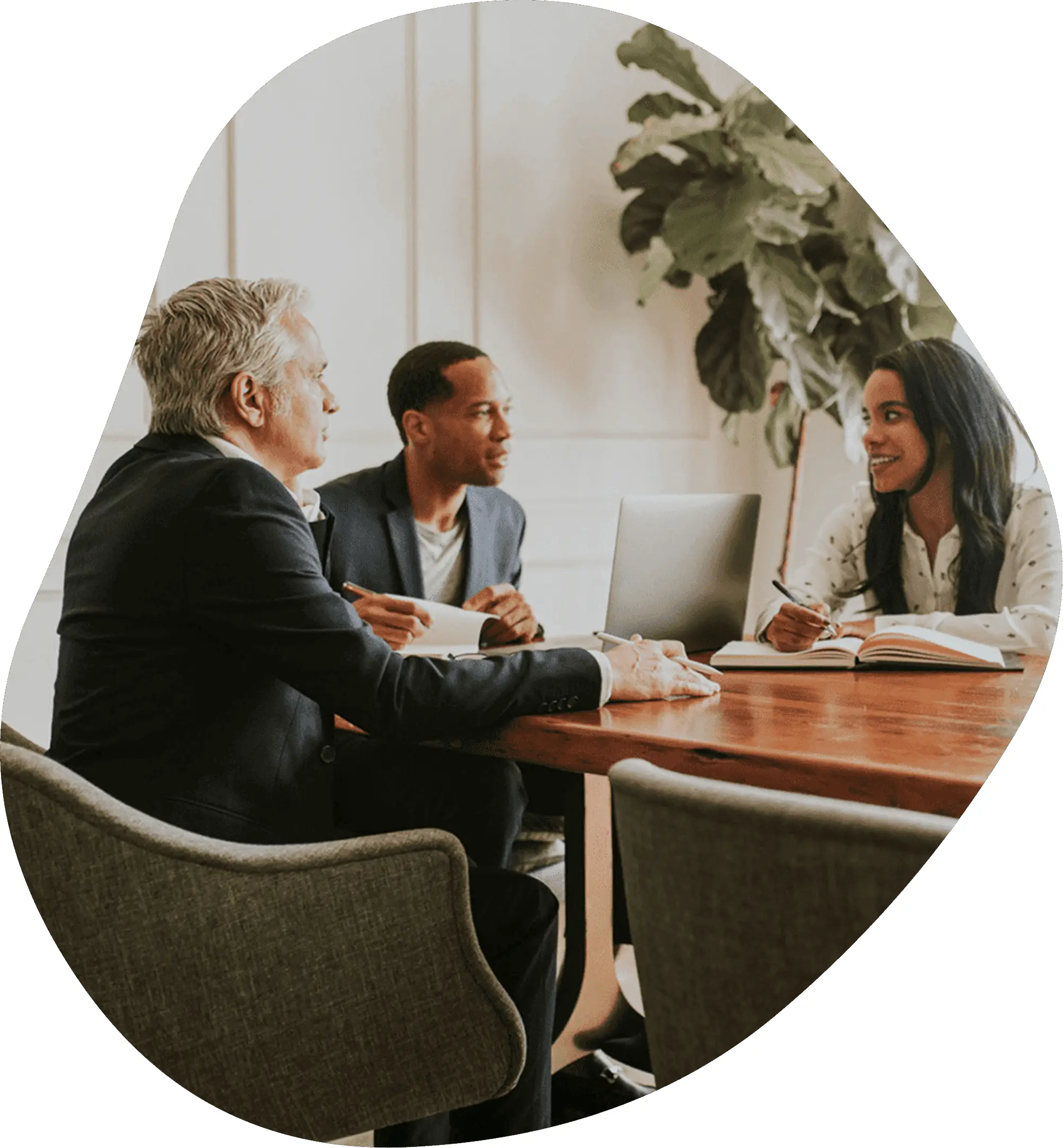 Three professionals collaborating around a wooden table